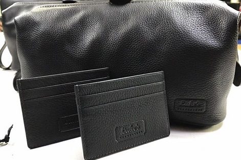 Luke's branded leather wash bag and card holders.